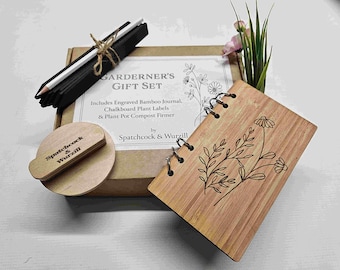 May include: A wooden gift set for gardeners, featuring a bamboo journal with a floral design, chalkboard plant labels, and a plant pot compost firmer. The set is packaged in a brown box with the text "GARDENER'S GIFT SET" and "Spatchcock & Wurzill" printed on it.