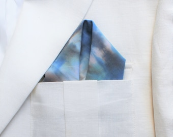 Cotton shibori hand dyed pocket squares in blue, white, grey and brown.