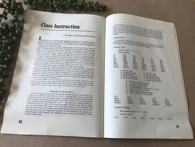 May include: Open book with text titled "Class Instruction" and "Lessons in Receiving." The pages display text and lists of words and phrases for learning. The book is open to pages 38 and 39.