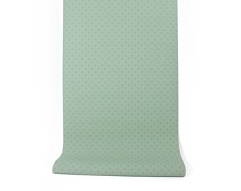 May include: A roll of light green wallpaper with a small white polka dot pattern.