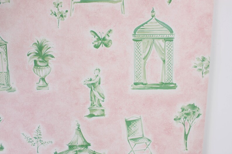 May include: Pink wallpaper with a green watercolor pattern of garden elements, including a gazebo, a statue, a potted plant, a butterfly, a chair, and a tree.