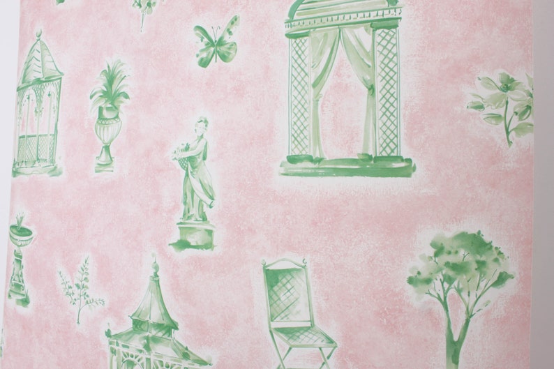 May include: A pink and green wallpaper pattern with a repeating design of garden elements, including a gazebo, a statue, a chair, a birdcage, a potted plant, a butterfly, and a tree.