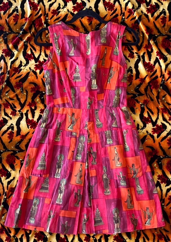 A genuine 1950s handmade dress with a wild Buddhist sculpture novelty print — the kind of one-of-a-kind vintage find you'd never stumble across elsewhere.