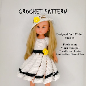 May include: Crochet pattern for a 13-inch doll, featuring a white dress with black trim and a white crocheted hat with a yellow flower. The doll has blonde hair and blue eyes. Designed for dolls such as Paola Reina, Maru mini pal, Corolle les cheries, and Little darling - Dianna Effner.