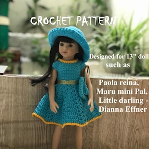 May include: A crochet pattern for a 13-inch doll dress and hat. The dress is turquoise blue with yellow trim and the hat is turquoise blue. The pattern is designed for dolls such as Paola Reina, Maru mini Pal, Little darling, and Dianna Effner.