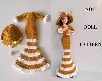 May include: Crochet pattern for a doll dress and hat. The dress is a long, striped dress with a fitted bodice and a flared skirt. The hat is a wide-brimmed sun hat with a flower embellishment. The pattern is titled "Lady Fashion #216 Not Doll Pattern" and is by Vinamigurumi.