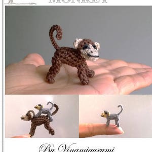 May include: Amigurumi pattern for a brown monkey with a long tail. The pattern is by Vinamigurumi. The image shows a crocheted monkey on a hand, and two smaller monkeys on fingers.