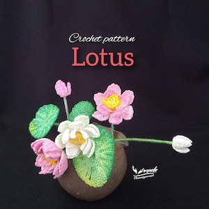 May include: A crochet pattern for a lotus flower arrangement. The arrangement includes pink and white lotus flowers with yellow centers, green leaves, and a brown vase. The text "Crochet pattern Lotus" is displayed.