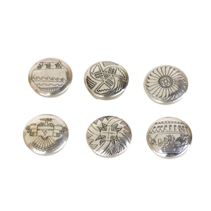 May include: A set of six circular silver buttons, each featuring distinct engraved patterns including geometric shapes, a sunburst, a bird motif, and linear designs. The buttons have a polished metallic finish and are arranged in two rows of three.