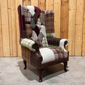 May include: A patchwork armchair with a high back and a tufted seat. The chair is upholstered in a variety of plaid fabrics in shades of brown, green, and red.