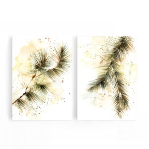 May include: Two watercolor prints featuring detailed depictions of pine branches. The branches are rendered in shades of green and brown, set against a soft, abstract background of yellow and beige hues. The artwork evokes a natural, botanical theme.