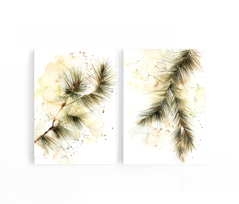 May include: Two watercolor prints featuring detailed depictions of pine branches. The branches are rendered in shades of green and brown, set against a soft, abstract background of yellow and beige hues. The artwork evokes a natural, botanical theme.