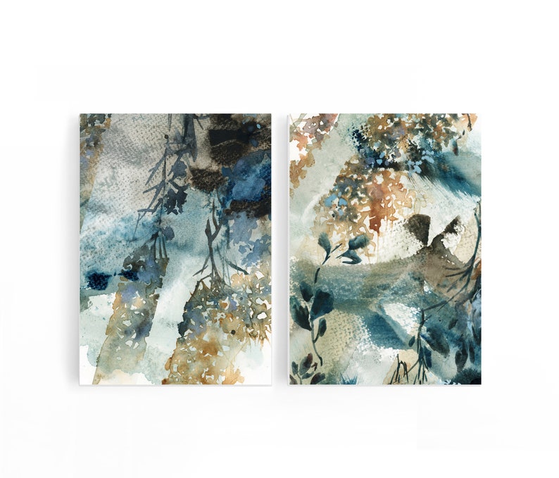 May include: Two abstract watercolor paintings. The artwork features a blend of blue, brown, and beige hues, with botanical elements. The paintings have a textured appearance, with visible brushstrokes and layered colors, creating a sense of depth and movement.