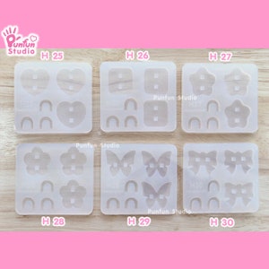 Könnte beinhalten: Ein Set mit zehn klaren Silikonformen zum Herstellen von Ohrringen. Die Formen sind in zwei Reihen mit jeweils fünf Formen angeordnet. Jede Form hat ein anderes Design, darunter Herzen, Quadrate, Sterne, Blumen und Schmetterlinge. Die Formen sind mit den Buchstaben H 25 bis H 30 beschriftet.