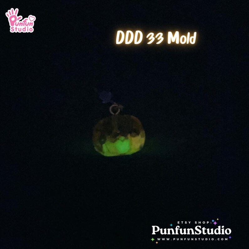 May include: A glow-in-the-dark pumpkin-shaped mold for crafting. The mold is made of a clear, flexible material and is shown in a dark setting, glowing green.
