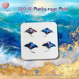 May include: A white card features four manta ray molds with a galaxy design. The manta rays are in shades of blue, purple, and pink. The card is set against a background of ocean waves and gold accents. Text on the card reads "DDD 76 Manta rays Mold."
