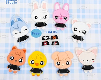 May include: A set of eight silicone molds for making cute animal characters. The molds are black with white details and feature a variety of animals, including a bunny, a pig, a fox, a cat, a dog, a chick, and a bear. The molds are labeled "PAM 101-108 Mold Set" and "GM 05".