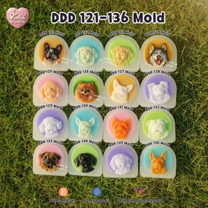 Puede incluir: Una colección de moldes de silicona con caras de perros detalladas. Cada molde es de una raza diferente, con el texto "DDD 121-136 Mold" en la parte superior. Los moldes están dispuestos en una cuadrícula.