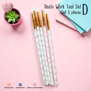 May include: A set of five resin work tools with white and gold accents. The tools have white, twisted handles and gold metal ferrules. The text "Resin Work Tool Set" and "Set 5 pieces" is visible.
