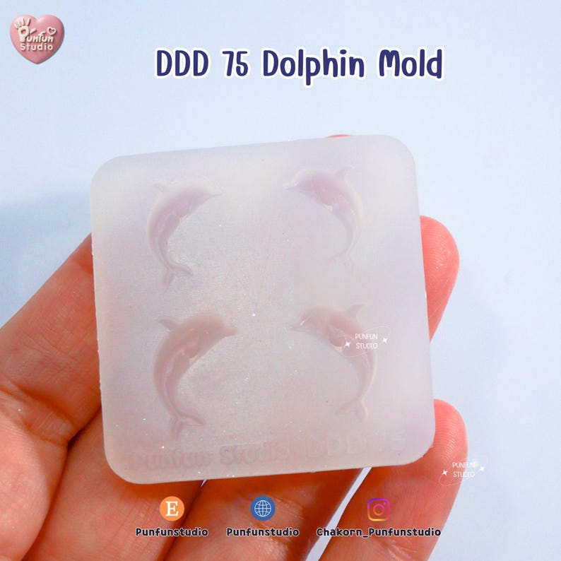 May include: A clear, square mold with four dolphin shapes. The text "DDD 75 Dolphin Mold" is printed at the top. The mold is held in a hand. The Punfun Studio logo is in the top left corner.