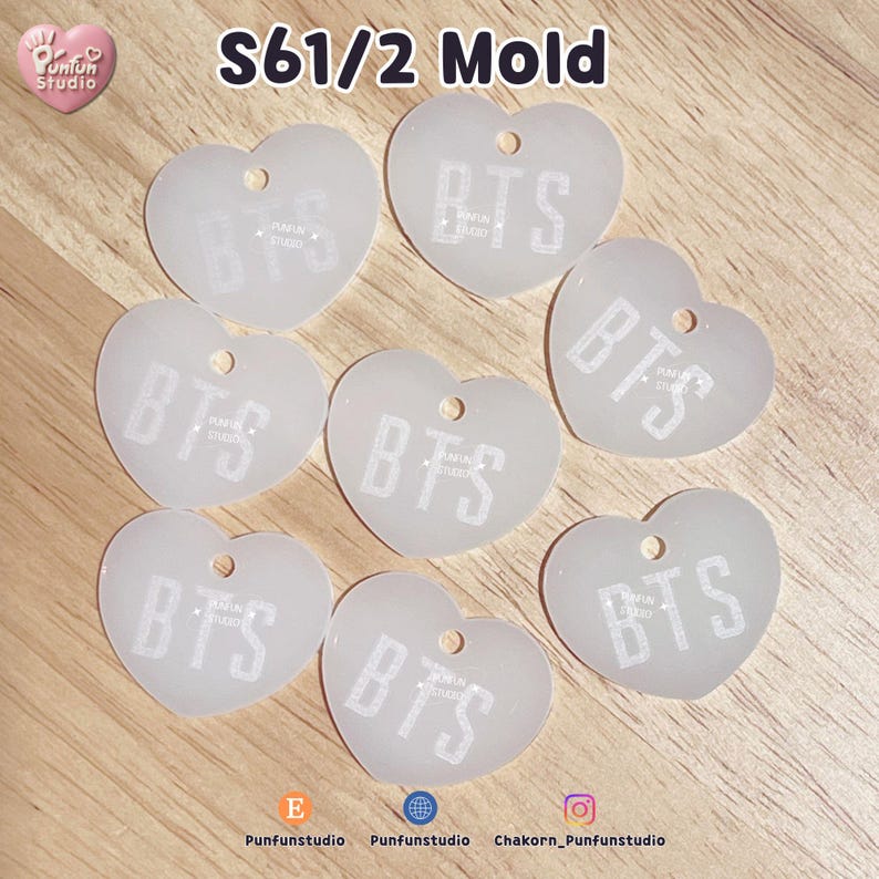May include: Seven translucent, heart-shaped acrylic charms, each featuring a small hole at the top and the white text "BTS" printed in the center. The text "S61/2 Mold" appears at the top, with "Punfun Studio" branding and social media icons below.