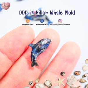 May include: A small, detailed killer whale mold with a black and blue design, held in a hand. The mold has the text "DDD 74 Killer Whale Mold" above it. The background includes seashells and the Punfun Studio logo.