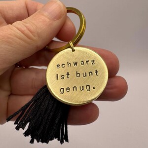 Schwarz ist bunt genug | hand stamped brass pendant with a black tassel | keychain German fun quote Black is colorful enough