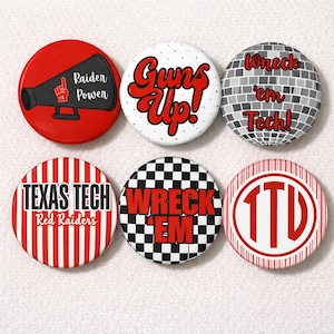 May include: A collection of six round buttons with various designs and text. The buttons feature phrases like "Raider Power," "Guns Up!," and "Wreck 'em Tech!" in red and white. Other buttons display "Texas Tech Red Raiders" and a checkered pattern.