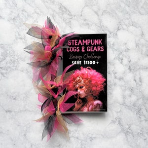 May include: A black and gold book with the title "Steampunk Cogs & Gears Savings Challenge Save $1500+" and a woman with pink hair and a steampunk-inspired outfit on the cover.