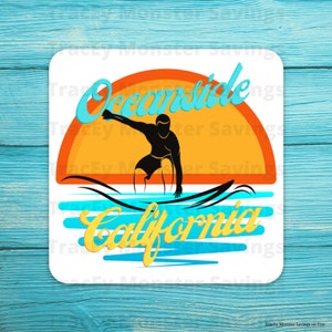 May include: A white background with a blue and orange sunset graphic. The text "Oceanside California" is in yellow with a silhouette of a surfer riding a wave.