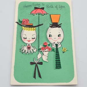 May include: Vintage Easter greeting card with a green background and the text "Happy Easter to Both of You." The card features illustrated egg-shaped characters, one with a hat and parasol, the other with a top hat, holding flowers.