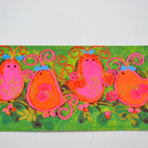 May include: A vintage Christmas card featuring four pink and orange birds with blue bows on a green background with gold accents.