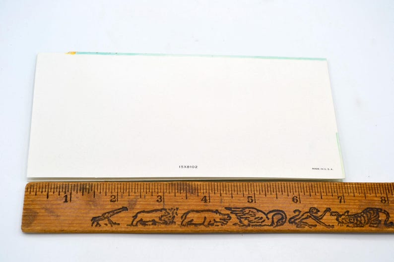 May include: A blank white card with a light blue line across the top. The card has the text "15X8102" printed in the bottom center.