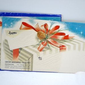 May include: Vintage merchandise parcel post cards with a festive design. Each card features a red bow, pinecone, and a gift box illustration. The cards have a blue border and text that reads "from" and "to".