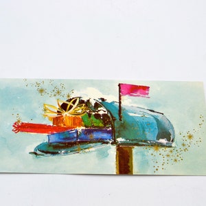 May include: A vintage greeting card featuring a teal mailbox overflowing with wrapped gifts. The illustration has a watercolor style with a pink flag, gold accents, and a light blue background.