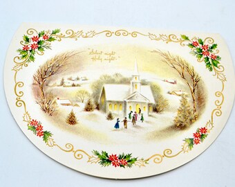 May include: A vintage Christmas card with a snowy winter scene. A white church with a steeple stands in the center of the scene, with a group of people gathered in front of it. The text "Silent night, Holy night" is written in gold lettering at the top of the card.