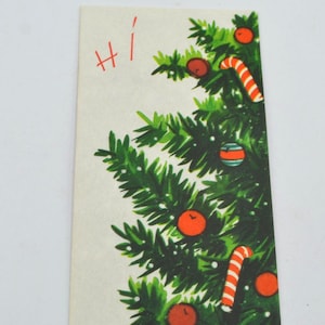 May include: A vintage Christmas card featuring a green Christmas tree decorated with red ornaments, candy canes, and a striped ornament. The card has the word "Hi" written in red. The card is rectangular and has a white background.