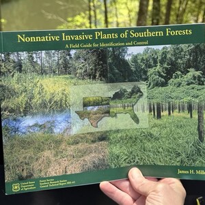 May include: A softcover book titled Nonnative Invasive Plants of Southern Forests: A Field Guide for Identification and Control by James H. Miller. The cover features a map of the Southern United States overlaid on various forest landscape photos.