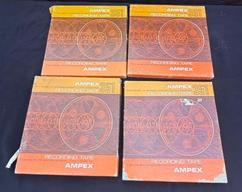 May include: Four vintage Ampex 351 recording tape boxes. Each box has an orange and brown color scheme with a reel design. The text "RECORDING TAPE" and "AMPEX" are visible on the boxes.