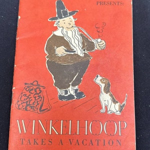 May include: A red book cover with a cartoon illustration of a man with a beard and a hat, holding a pipe and a bag. The man is standing next to a dog. The text on the cover reads "New York Central Presents: Winkelhoop Takes a Vacation."
