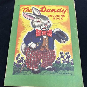 May include: A vintage coloring book cover featuring a cartoon rabbit dressed in a suit and holding a top hat. The title of the book is "The Dandy Coloring Book" and the artist's name is "Mild Winter".