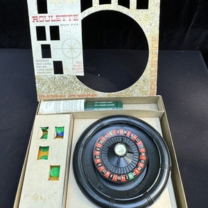 May include: A vintage Transogram Roulette Out Fit game in its original box. The game includes a black roulette wheel, green and blue chips, and a vinyl plastic roulette layout.