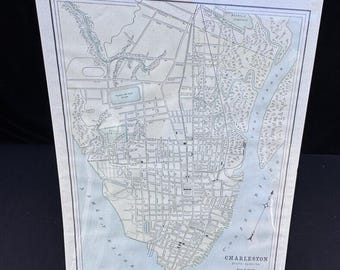 May include: An antique map of Charleston, South Carolina, printed in black and white with blue and green accents. The map shows the city's streets, waterways, and parks. The title "Charleston, South Carolina" is printed at the bottom of the map.
