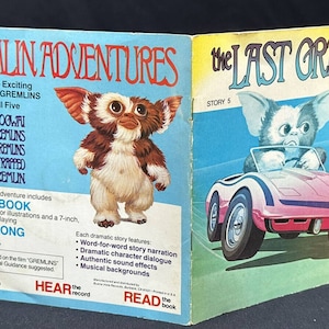 May include: A Gremlins book and record set featuring a furry, brown and white creature with large ears. The book cover shows the creature driving a pink car. The text on the cover reads "The Last Gremlin" and "Story 5".