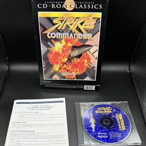 May include: A vintage "Strike Commander" CD-ROM game box set. The box features a jet fighter graphic with an explosion. Includes the game CD and a manual. The CD case reads "Tactical Operations".