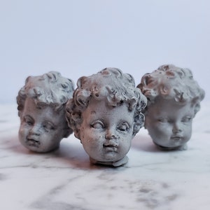Creepy tiny cherub baby head cement decorations for potted plants or fairy gardens
