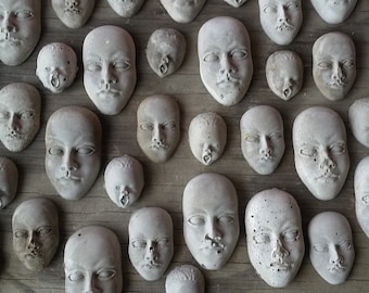 Creepy cement face decorations for potted plants or fairy gardens