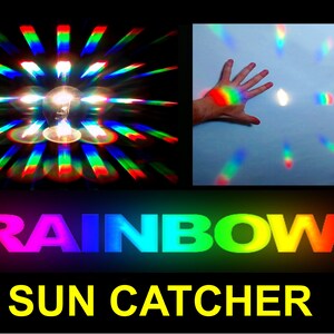 May include: The image shows a light bulb creating rainbow light patterns. A hand is shown with a rainbow spectrum on it. The word "RAINBOW" is displayed in vibrant colours, with "SUN CATCHER" below it in yellow.