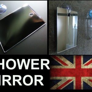 Op de afbeelding: Een rechthoekige douchespiegel met een zuignap voor eenvoudige montage. De spiegel is helder en reflecterend, met een klein gaatje om op te hangen. De tekst "SHOWER MIRROR" is ook inbegrepen.