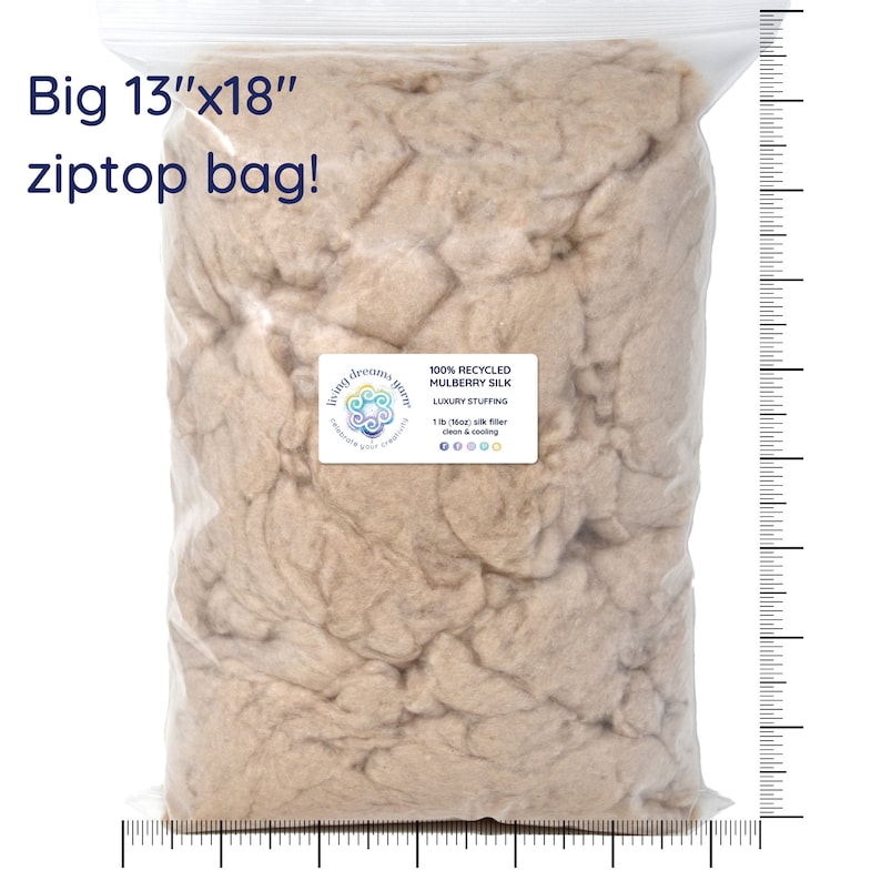 May include: A large, clear plastic bag filled with a beige, fluffy material. The bag is labeled "100% Recycled Mulberry Silk Luxury Stuffing 1 lb (Max) silk filler clean & cooling" and has a logo that says "living dreams green". The bag is 13 inches by 18 inches.
